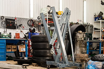Auto Repair Shop Interior With Engine Hoist And Tires