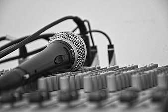 Black and white microphone on audio mixing console