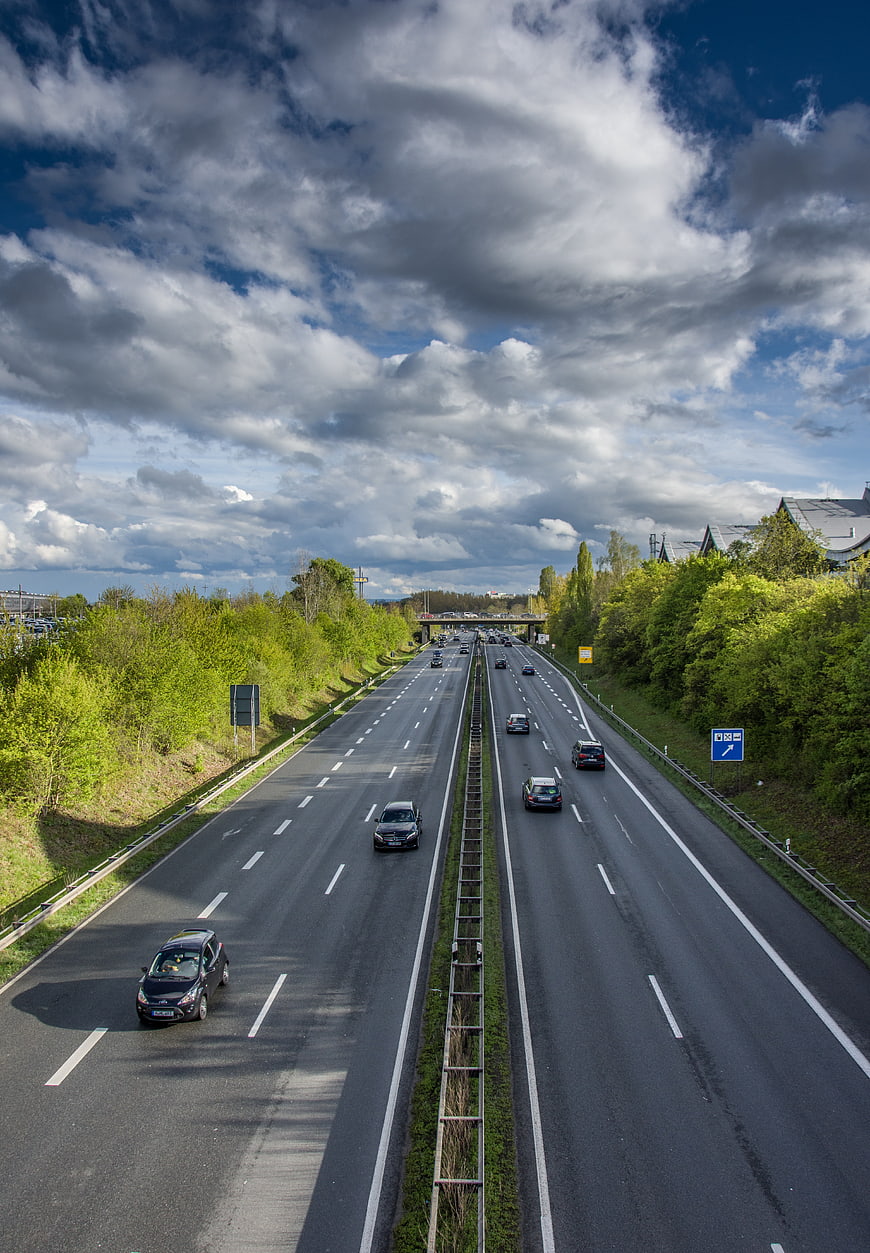 Highway Traffic Flow Under Dramatic Cloudy Sky