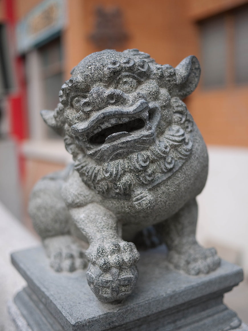 Close-up of traditional Chinese stone guardian lion statue