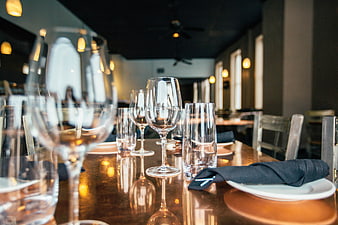 Elegant restaurant table setting with wine glasses and napkins