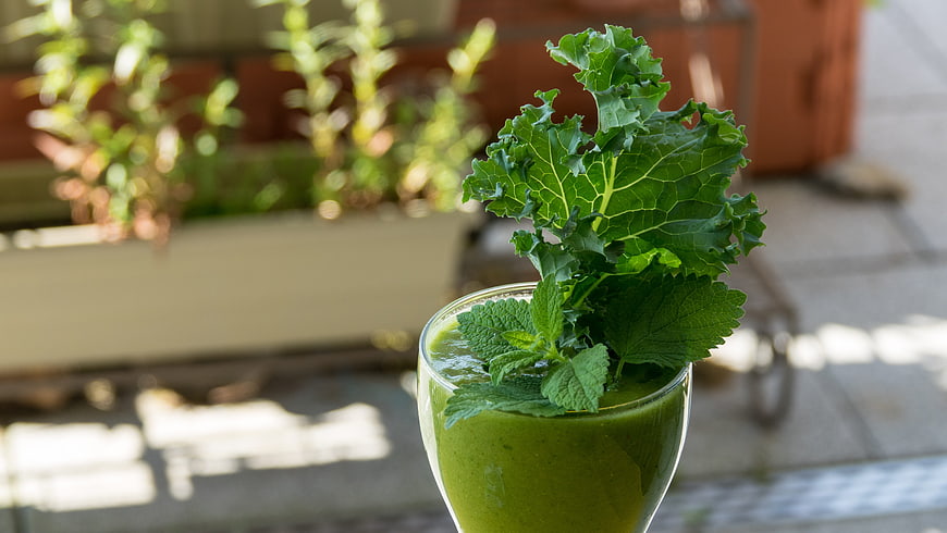 Fresh Green Kale Smoothie with Mint Garnish in Glass