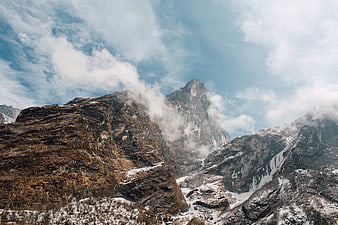 Majestic Rocky Mountain Peak with Snow and Clouds