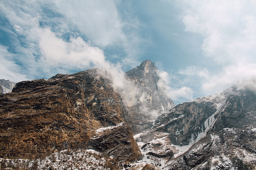 Majestic Rocky Mountain Peak with Snow and Clouds