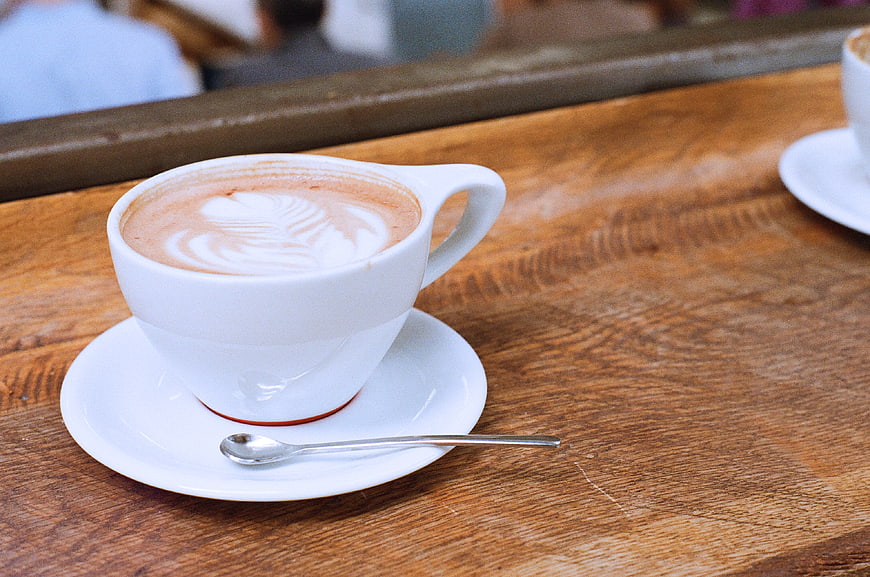 Latte Art Coffee Cup on Rustic Wooden Table