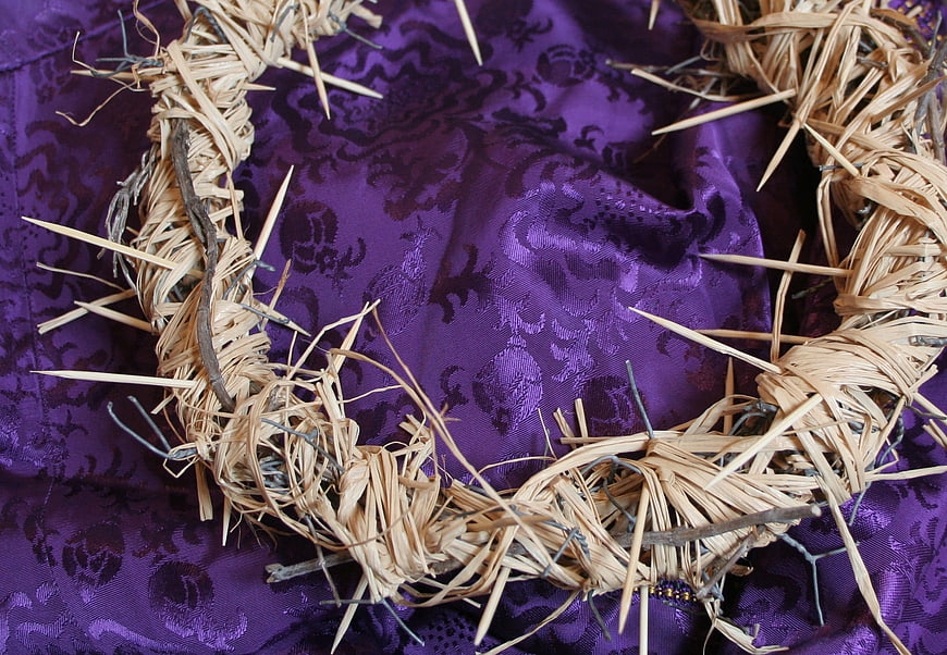 Crown of thorns on purple fabric religious symbol