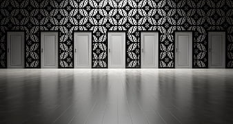 Seven white doors in a room with black and white patterned wallpaper