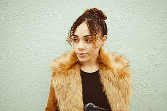 Woman in Fur Vest Against Textured Wall