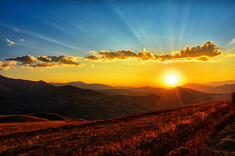 Golden Sunset Over Rolling Mountain Ridges