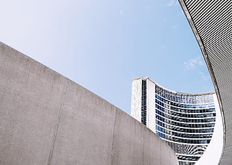 Modern curved concrete architecture against blue sky