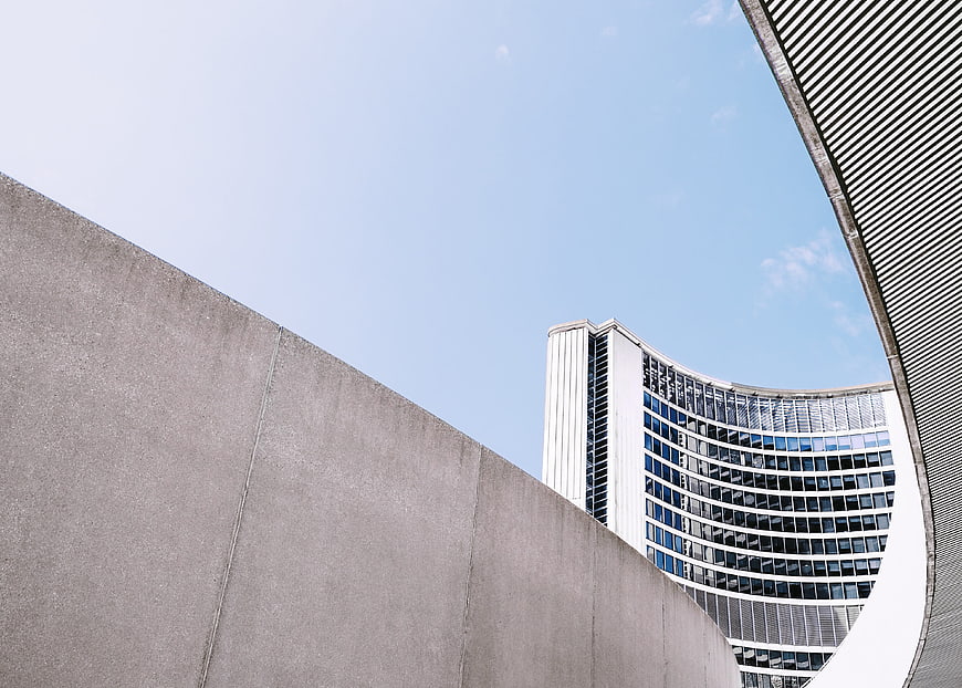 Modern curved concrete architecture against blue sky