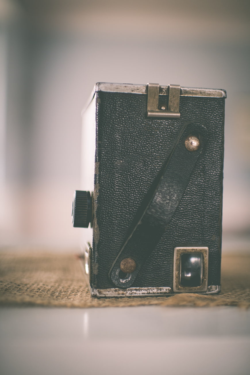 Vintage Box Camera on Burlap Surface