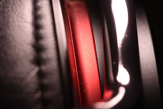 Close-up of red and black headphones with leather texture