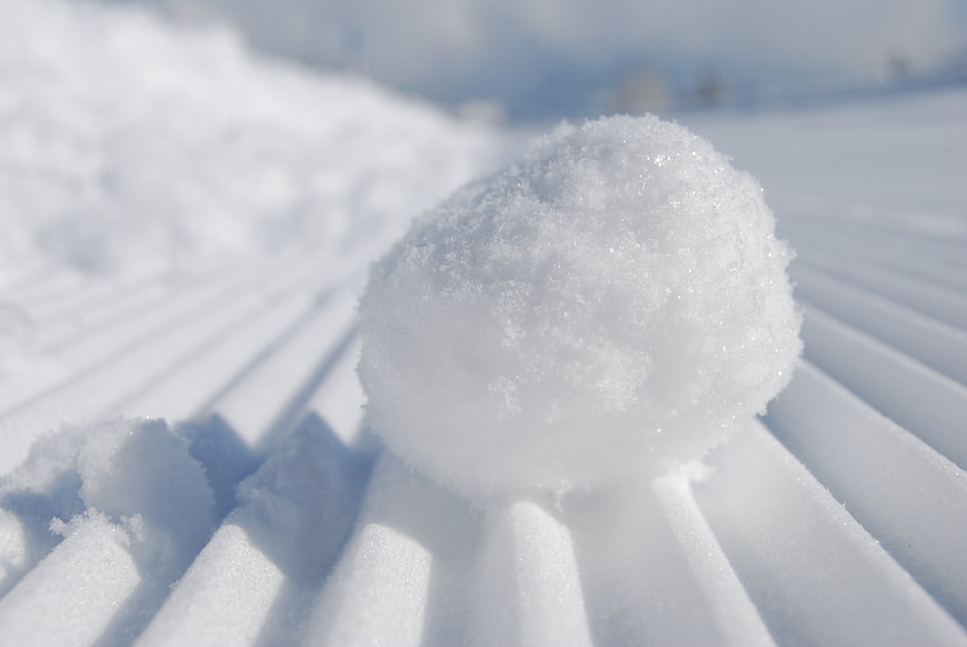 Snowball on Sifted Snow Surface in Winter Landscape
