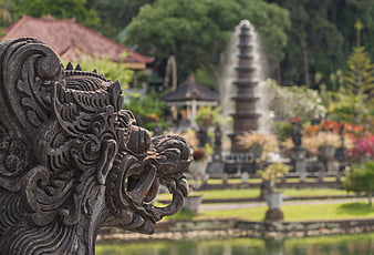 Bali Water Palace Dragon Statue With Blurred Fountain Background