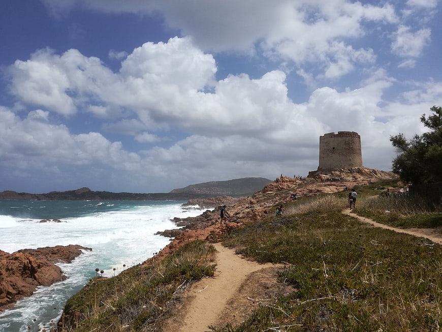 Coastal path leading to historic tower in Sardinia
