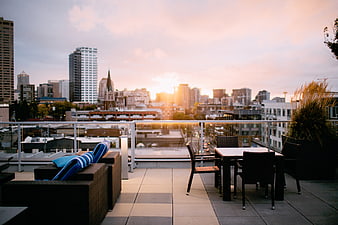 Modern Rooftop Terrace with City Skyline at Sunset
