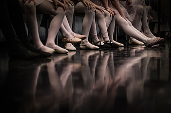 Ballet dancers legs and feet on stage floor