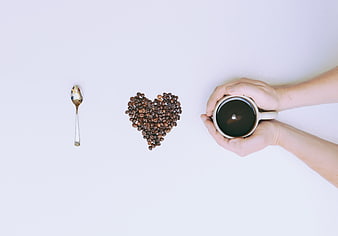Top View Coffee Cup and Heart Shaped Beans on White