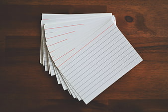 Stack of blank ruled paper on wooden table