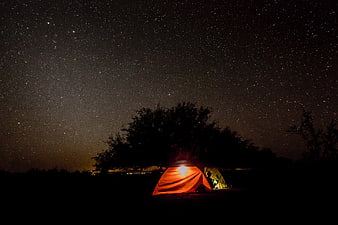 Glowing Camping Tent Under Starry Night Sky