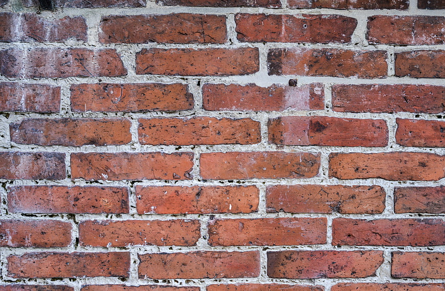 Close-up texture of old red brick wall with white mortar