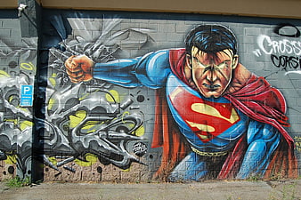 Superman breaking through wall graffiti mural