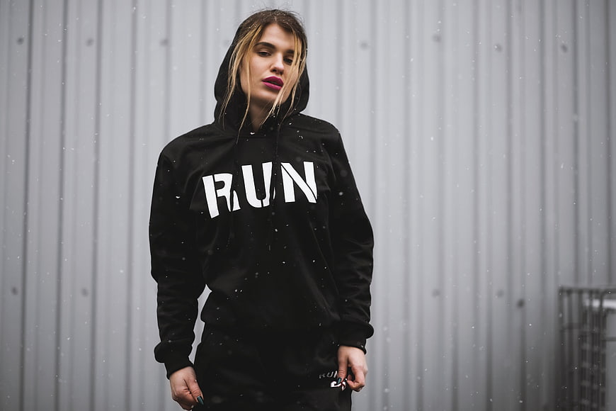 Woman in Black Hoodie with RUN Text in Rain