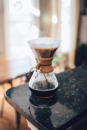 Pour-over coffee brewing on a dark marble table