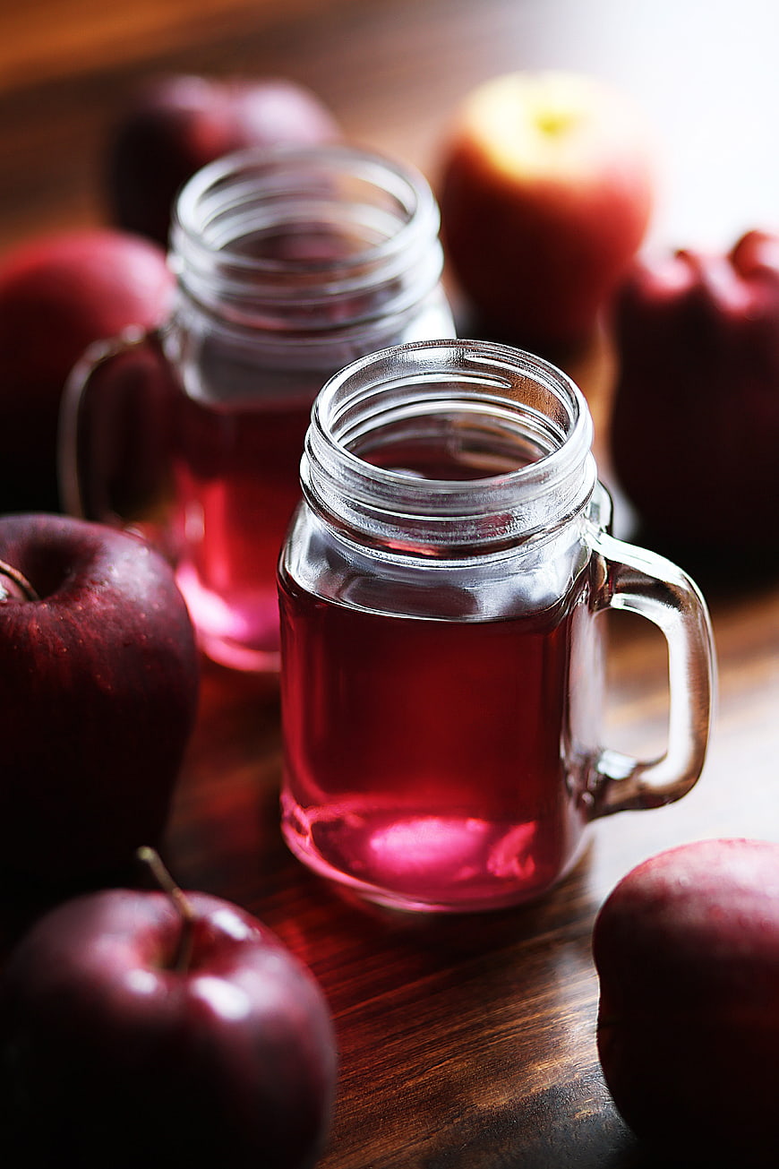 Fresh Apple Juice in Mason Jars with Red Apples