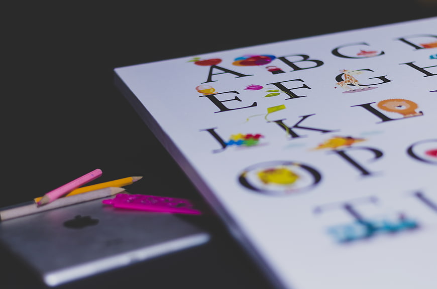 Colorful Alphabet Chart with Pencils and Tablet for Kids Learning