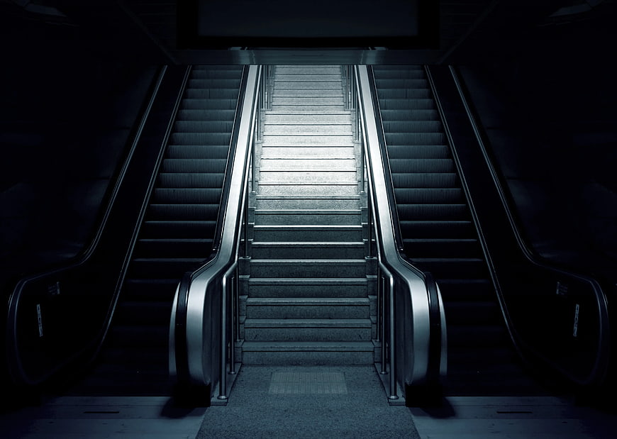 Symmetrical Escalators and Staircase in Dark Underground Station