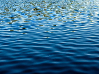 Deep Blue Water Surface with Gentle Ripples and Reflections