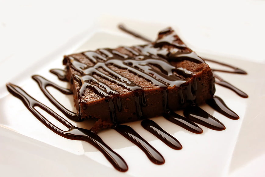 Square Chocolate Brownie Drizzled with Dark Chocolate Sauce