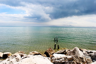 Dramatic coastal landscape with rocky shore and storm clouds