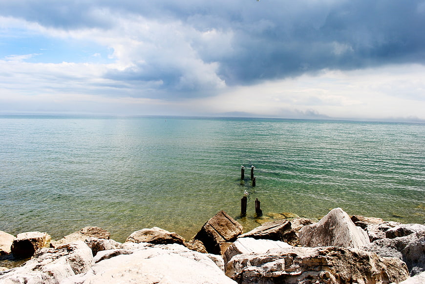 Dramatic coastal landscape with rocky shore and storm clouds