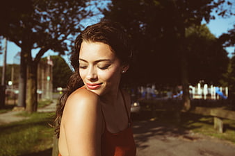 Serene Brunette Woman Portrait in Sunlit Park