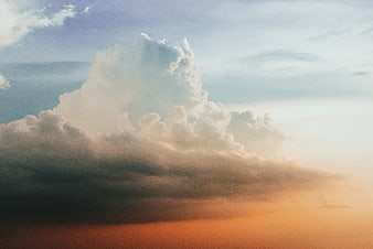 Dramatic cumulus cloud formation against sunset sky