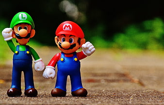 Mario and Luigi figurines standing on a path