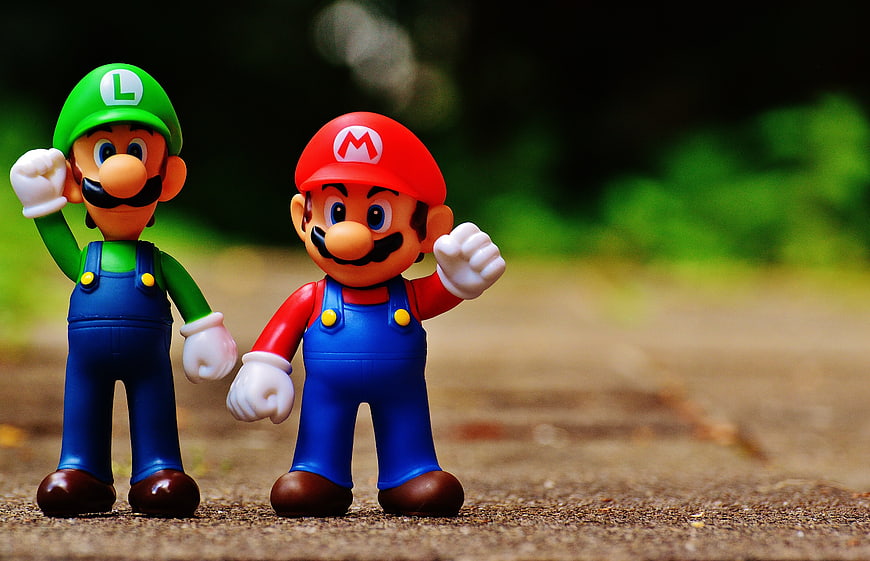 Mario and Luigi figurines standing on a path