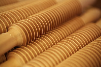 Close-up of wooden rolling pins with grooved texture