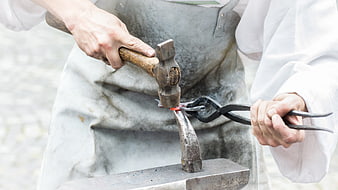 Blacksmith Forging Hot Metal on Anvil with Hammer