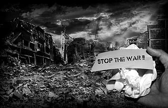 Hand holding stop the war sign in war-torn ruins