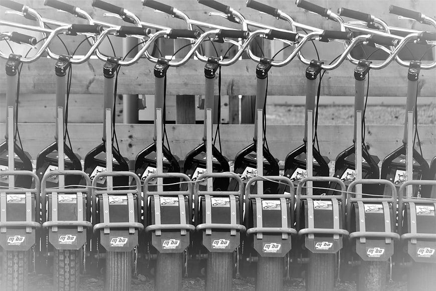 Black and white row of parked electric scooters