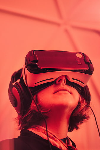 Woman Wearing VR Headset and Headphones in Red Light