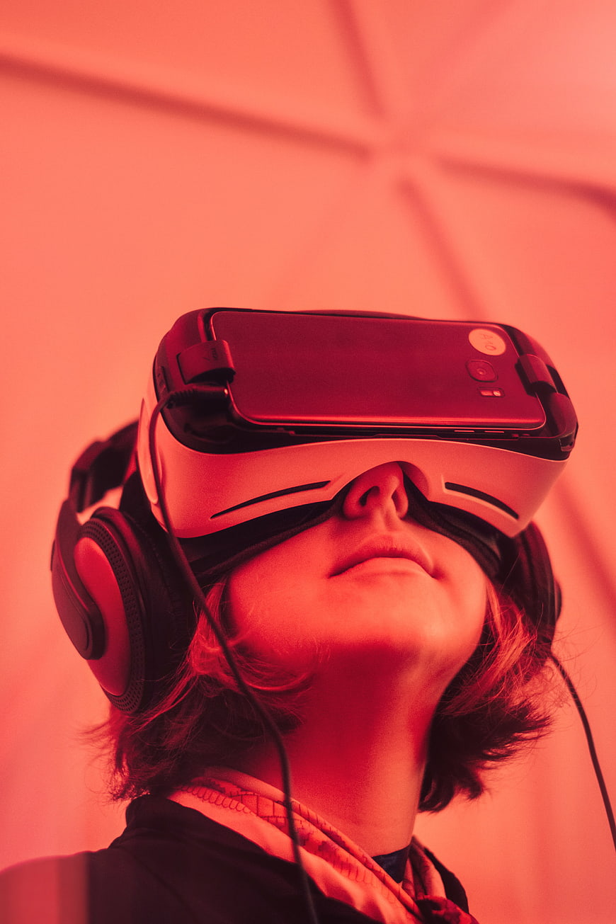 Woman Wearing VR Headset and Headphones in Red Light