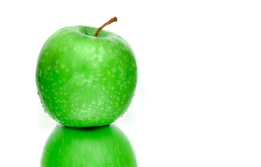 Fresh Green Apple with Water Droplets on White Background