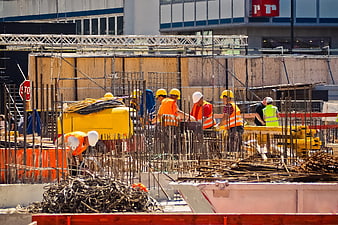 Construction workers building concrete foundation with rebar