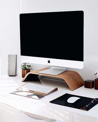 Minimalist white desk with iMac on wooden stand