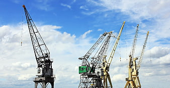 Industrial Cranes Against Blue Sky